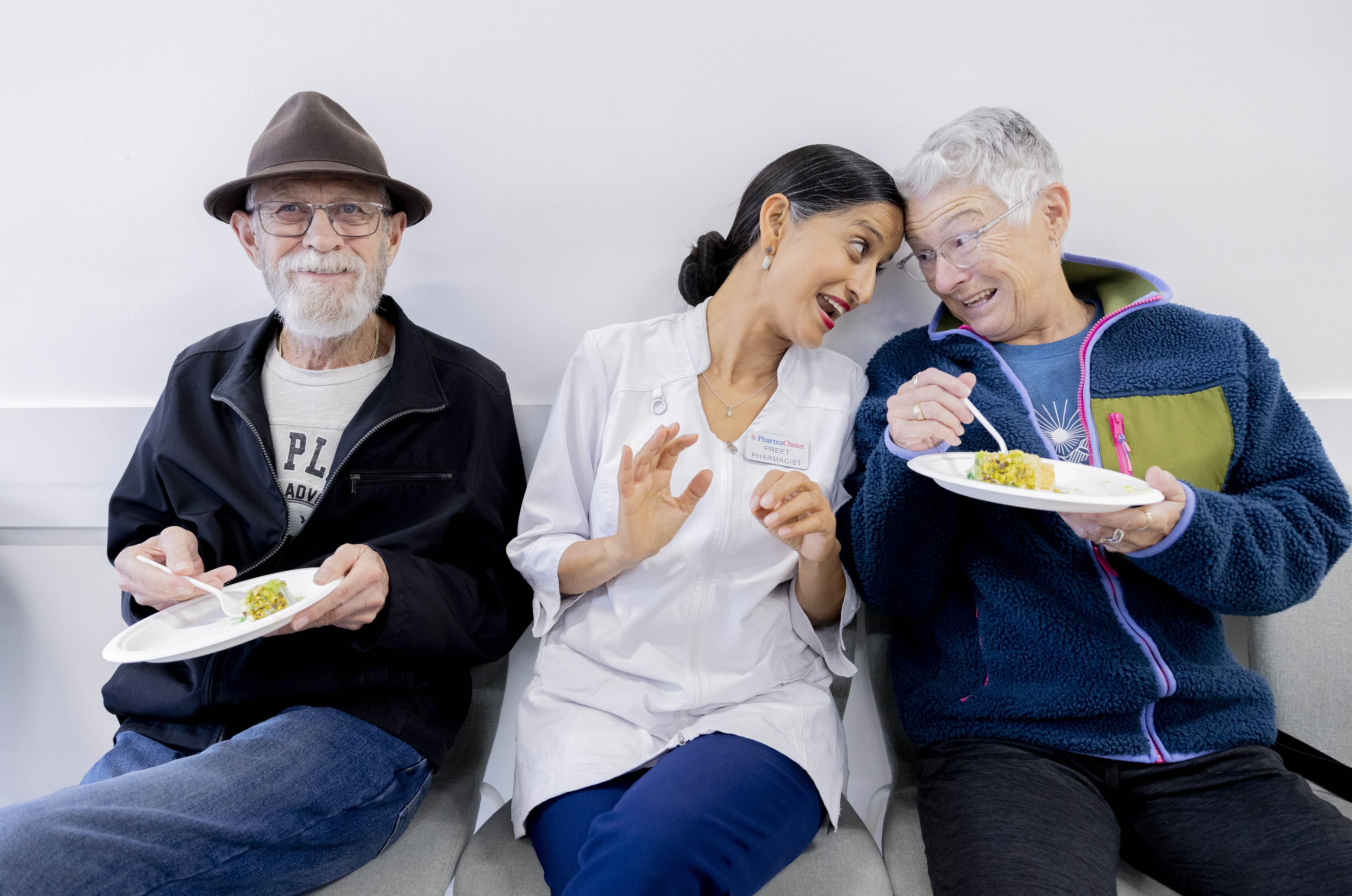 Pharmacist sharing a meal with senior patients