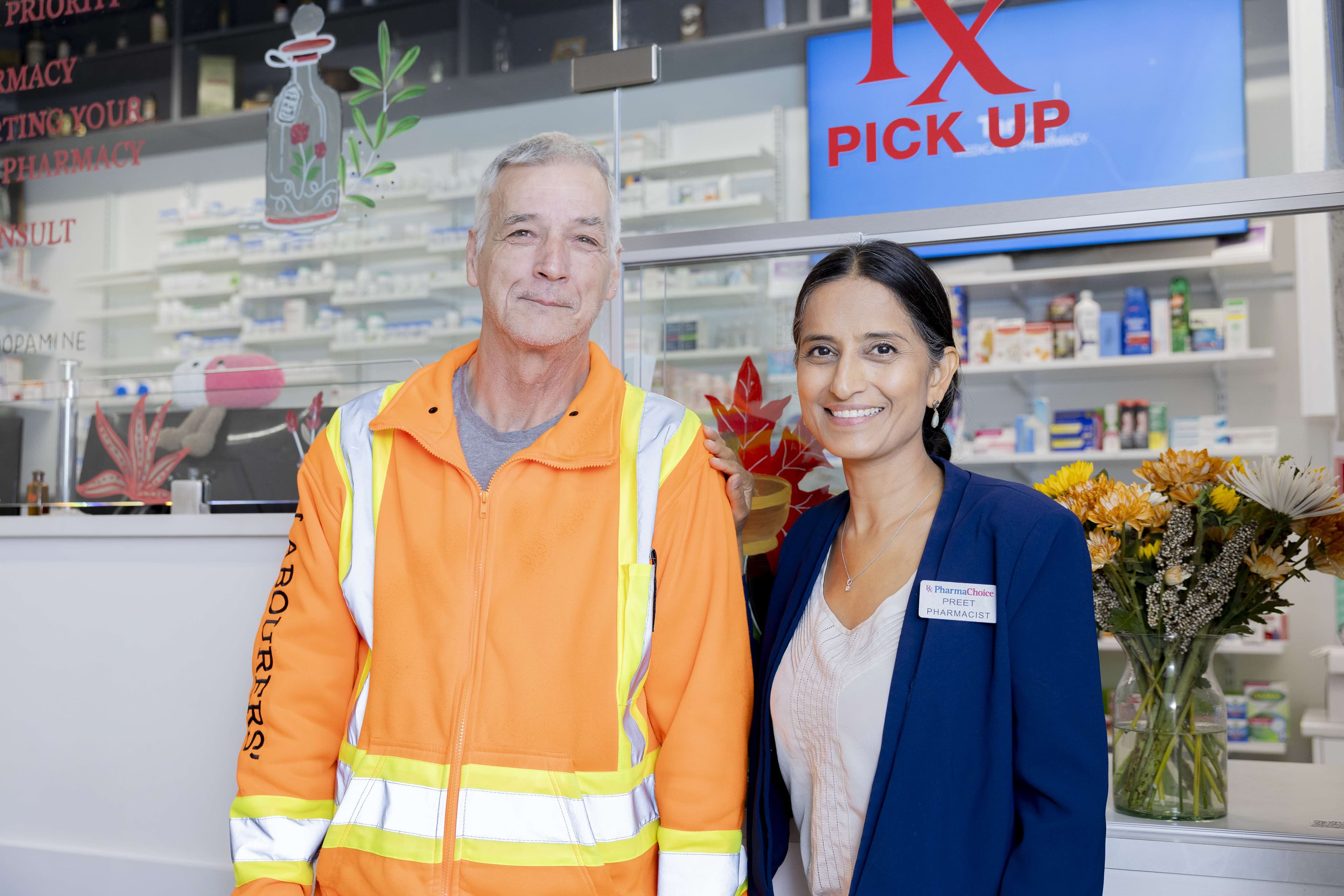 Pharmacist with tradesperson at prescription pickup
