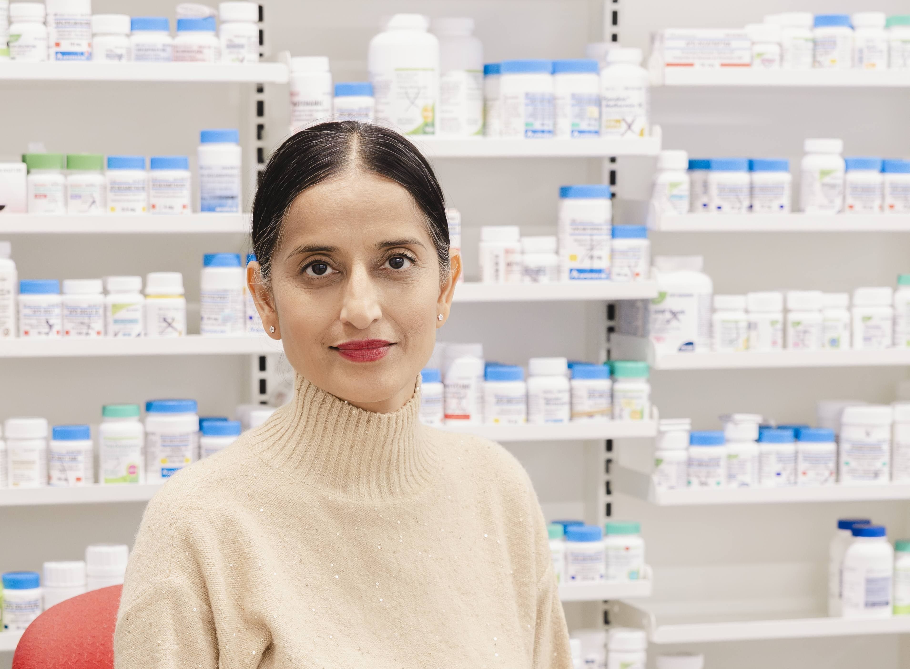 Staff portrait with medication shelves